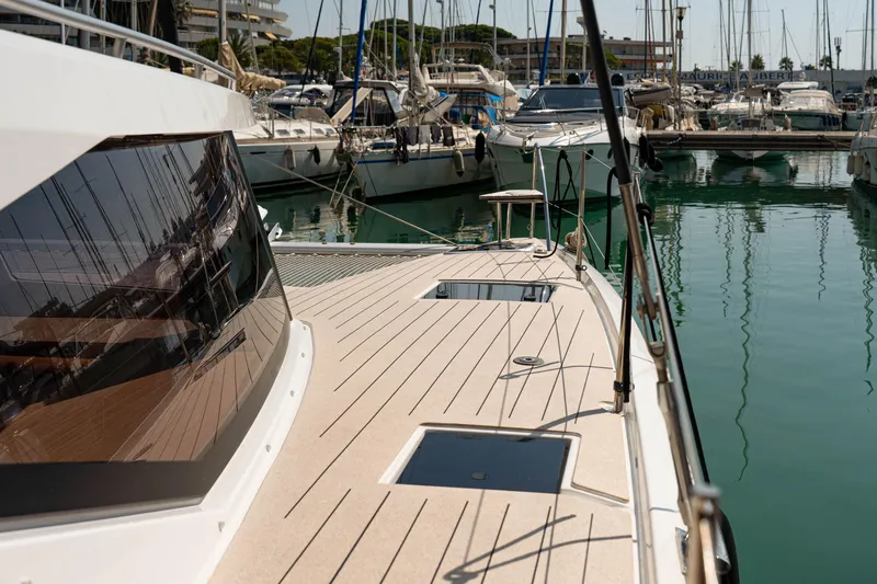  Yacht Photos Pics 2023 Fountaine Pajot Isla 40 catamaran docked in a marina, showcasing sleek deck design.