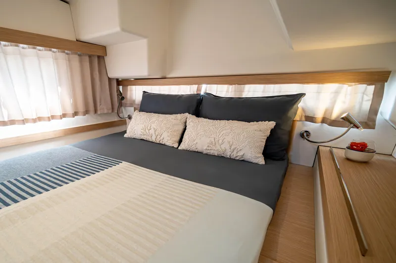 Yacht Photos Pics Luxurious bedroom interior of 2023 Fountaine Pajot Isla 40 catamaran with elegant bedding.