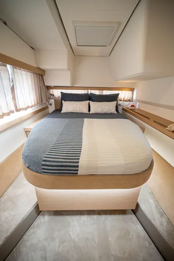  Yacht Photos Pics Luxurious bedroom interior of 2023 Fountaine Pajot Isla 40 catamaran, featuring a cozy double bed.