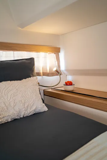  Yacht Photos Pics Cozy cabin interior of 2023 Fountaine Pajot Isla 40 with elegant bedding and soft lighting.
