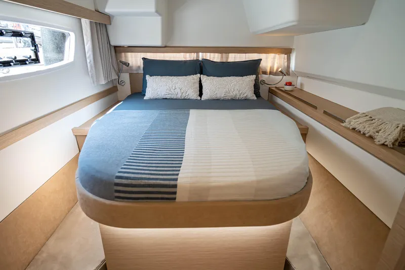  Yacht Photos Pics Luxurious cabin interior of 2023 Fountaine Pajot Isla 40 catamaran with cozy bed and modern design.
