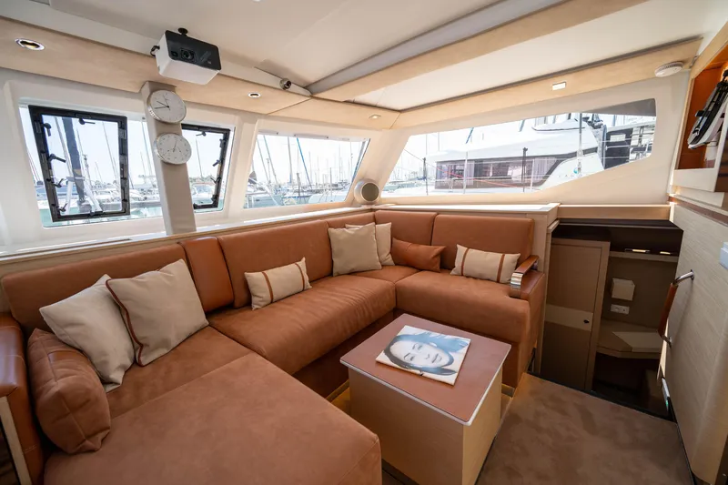  Yacht Photos Pics Luxurious interior of 2023 Fountaine Pajot Isla 40 catamaran with plush seating and modern decor.