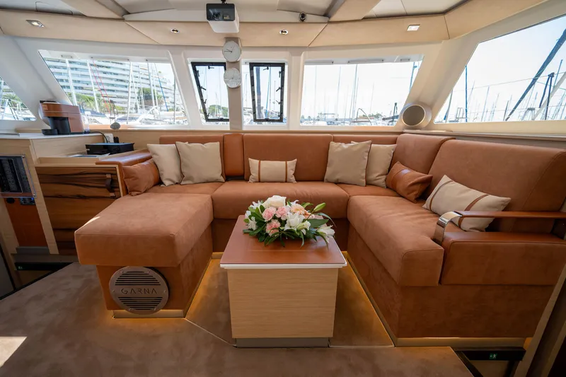  Yacht Photos Pics Luxurious interior of 2023 Fountaine Pajot Isla 40 catamaran with plush seating and elegant decor.