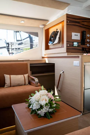  Yacht Photos Pics Luxurious interior of 2023 Fountaine Pajot Isla 40 catamaran with elegant floral arrangement.