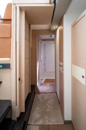  Yacht Photos Pics Interior hallway of 2023 Fountaine Pajot Isla 40 catamaran, featuring modern design and wood finishes.