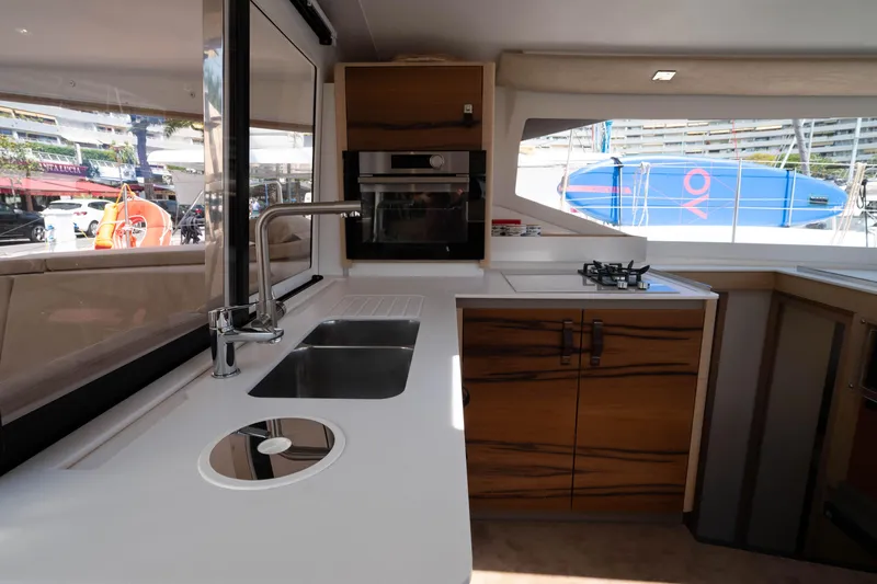  Yacht Photos Pics Modern kitchen interior of 2023 Fountaine Pajot Isla 40 catamaran, featuring sleek design and appliances.