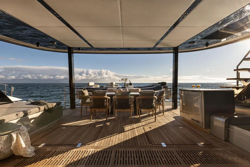 Otoctone Yacht Photos Pics Luxurious Sunreef 80 sailing yacht deck, 2024 model, with elegant outdoor dining area and ocean view.