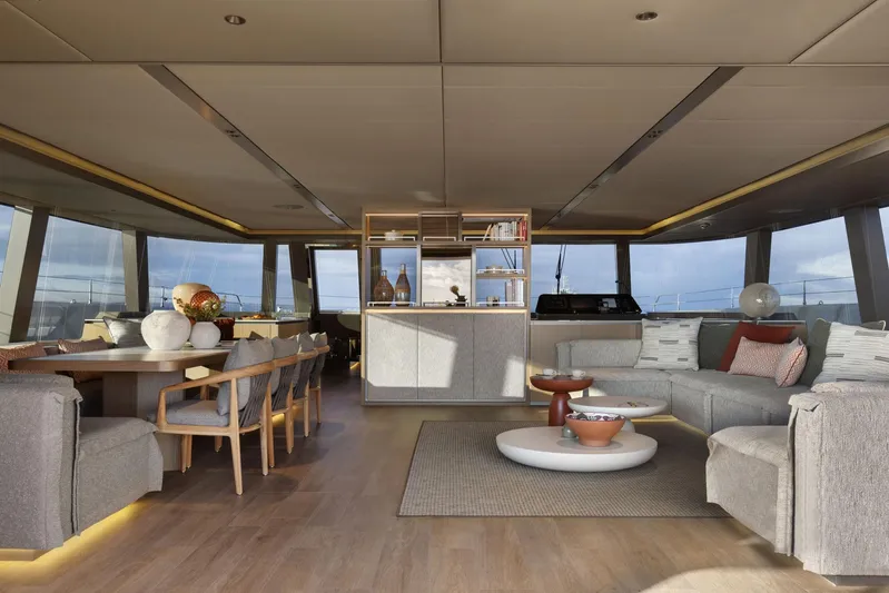 Otoctone Yacht Photos Pics Luxurious interior of 2024 Sunreef 80 sailing yacht with modern furnishings and panoramic windows.