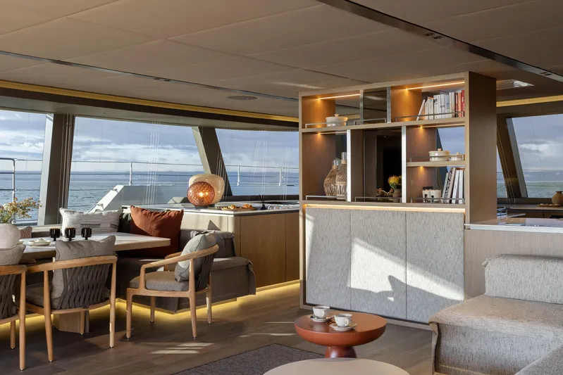 Otoctone Yacht Photos Pics Luxurious interior of 2024 Sunreef 80 sailing yacht with modern furnishings and panoramic windows.