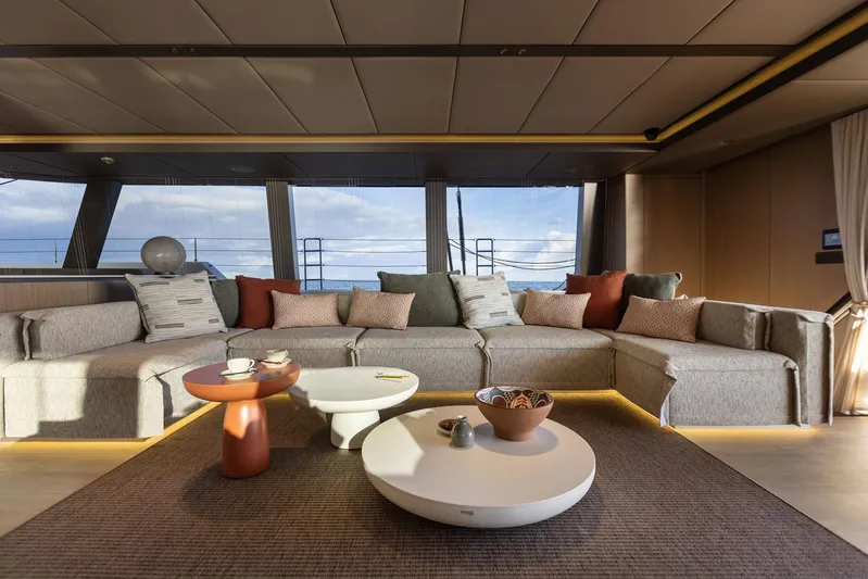 Otoctone Yacht Photos Pics Luxurious interior of 2024 Sunreef 80 sailing yacht with modern seating and elegant decor.