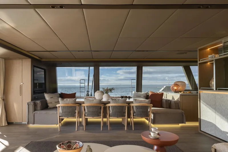 Otoctone Yacht Photos Pics Luxurious interior of 2024 Sunreef 80 sailing yacht with ocean view and elegant furnishings.