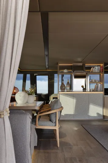 Otoctone Yacht Photos Pics Luxurious interior of 2024 Sunreef 80 sailing yacht with modern furnishings and ocean view.