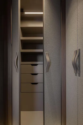 Otoctone Yacht Photos Pics Luxurious closet interior in 2024 Sunreef 80 Sailing yacht, featuring sleek shelves and drawers.