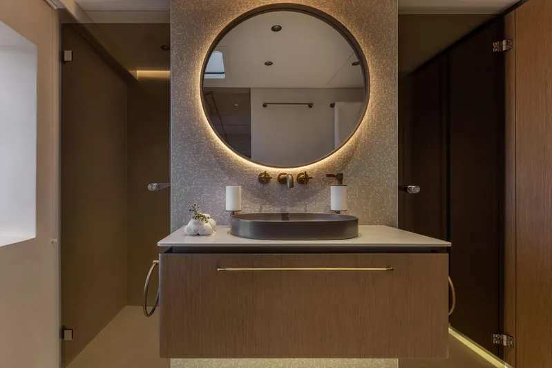 Otoctone Yacht Photos Pics Luxurious bathroom on 2024 Sunreef 80 sailing yacht with modern vanity and round mirror.