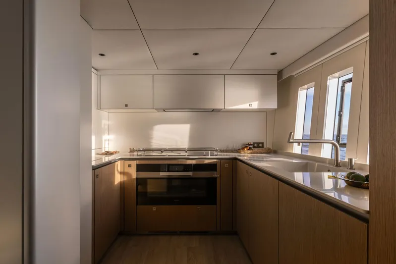 Otoctone Yacht Photos Pics Luxurious kitchen interior on 2024 Sunreef 80 sailing yacht, featuring modern appliances and sleek design.
