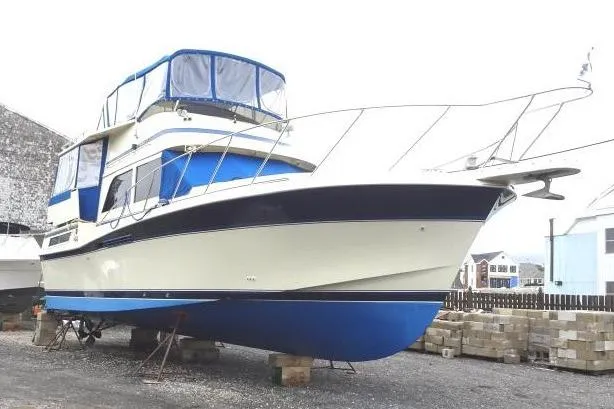 1985 Chris-Craft 426 Catalina yacht on dry dock, featuring blue and white design.