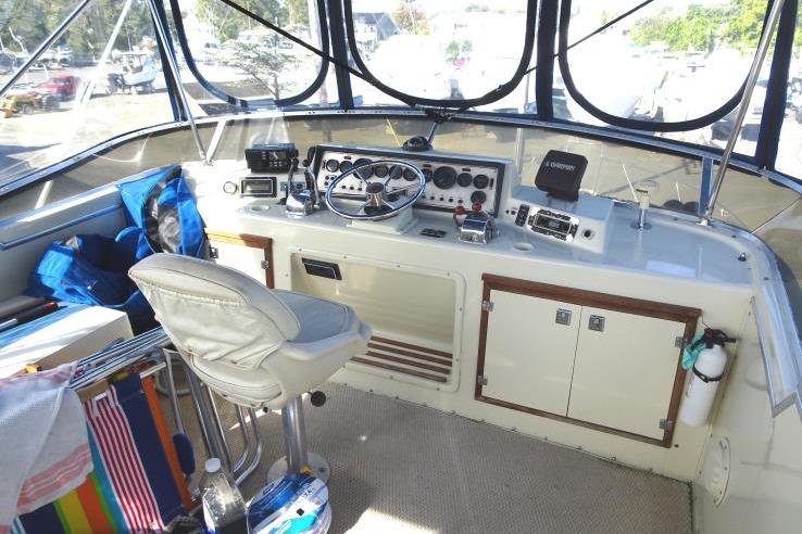 1985 Chris-Craft 426 Catalina helm with steering wheel, controls, and navigation equipment.