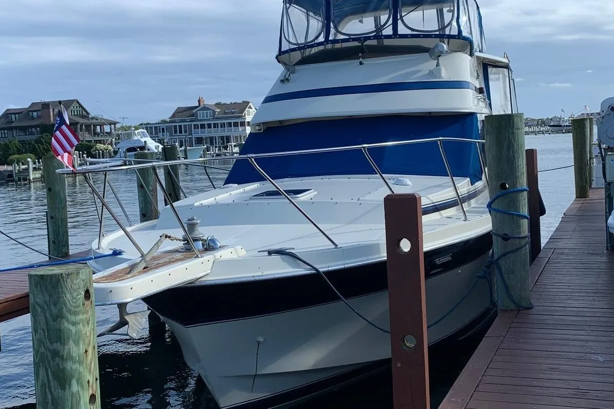 1985 Chris-Craft 426 Catalina yacht docked at a marina, featuring blue and white design.