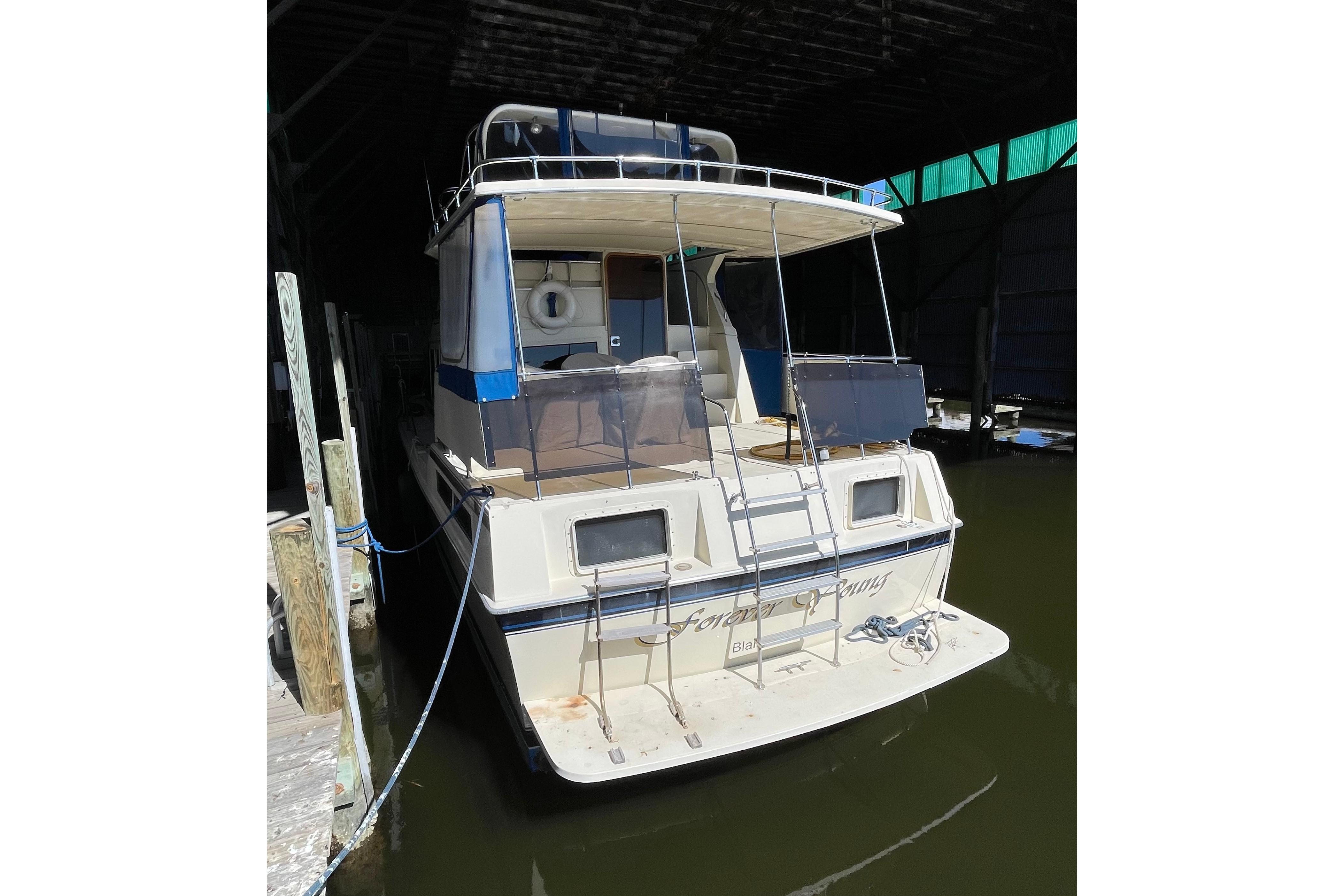 1985 Chris-Craft 426 Catalina yacht docked in a covered marina.