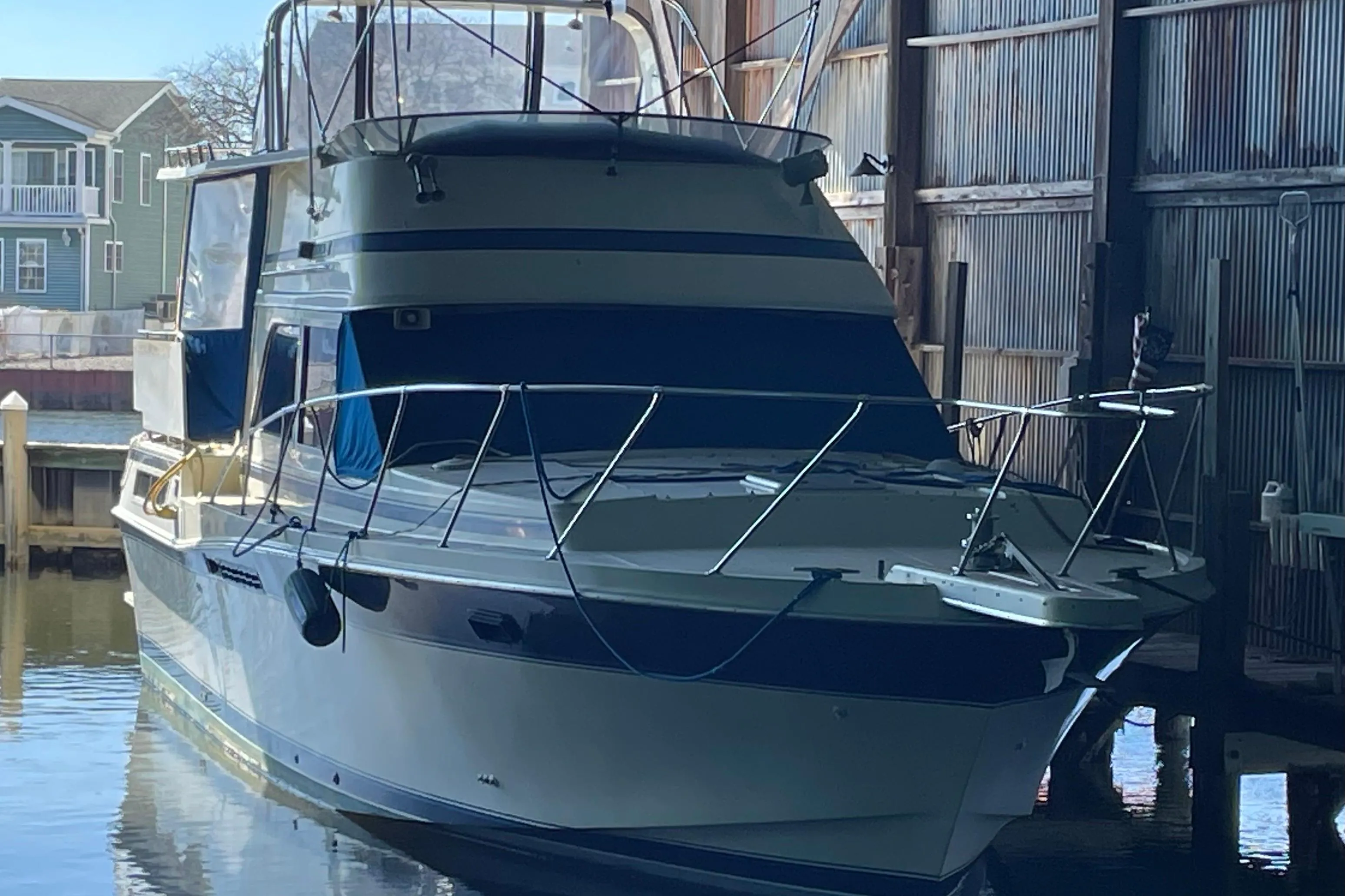 1985 Chris-Craft 426 Catalina yacht docked in a marina shed.