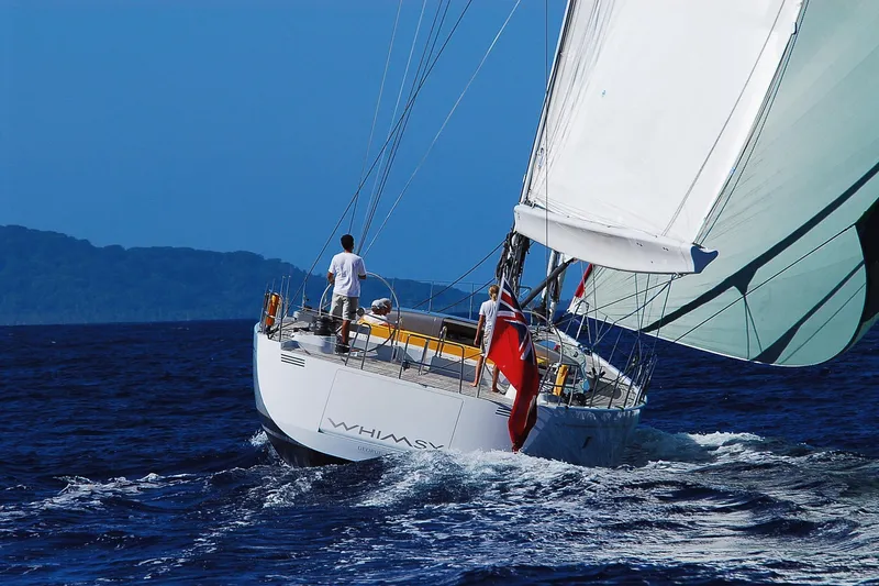 Whimsy Yacht Photos Pics Sailing yacht Vaudrey Miller 78, 2005 model, navigating ocean waters under clear blue skies.