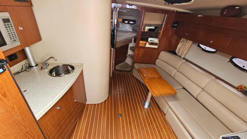  Yacht Photos Pics Interior of 2007 Regal 3760 Commodore yacht with kitchenette and seating area.