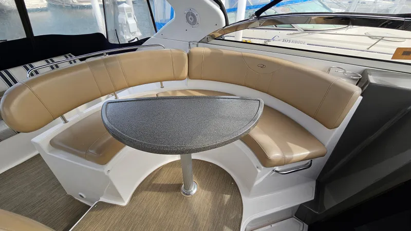  Yacht Photos Pics 2007 Regal 3760 Commodore boat interior with curved seating and table.