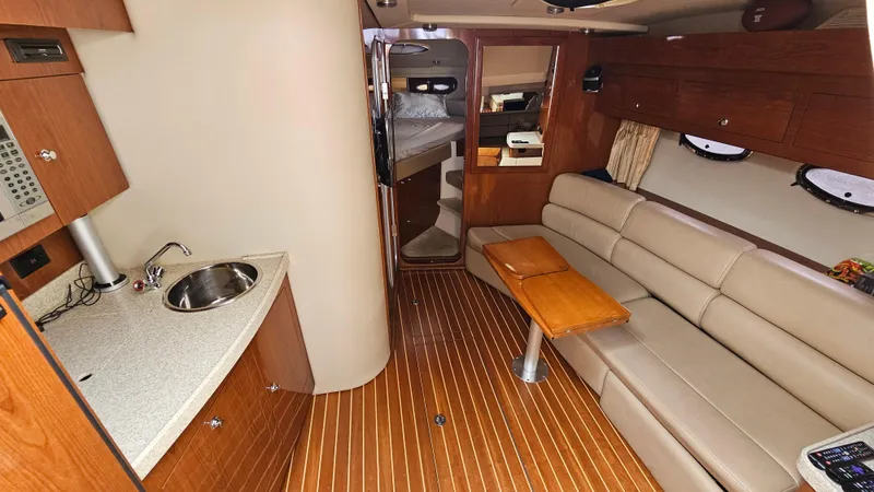  Yacht Photos Pics Interior of 2007 Regal 3760 Commodore yacht with kitchenette and seating area.