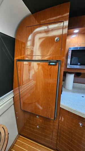  Yacht Photos Pics 2007 Regal 3760 Commodore yacht interior with wood cabinetry and compact kitchen amenities.