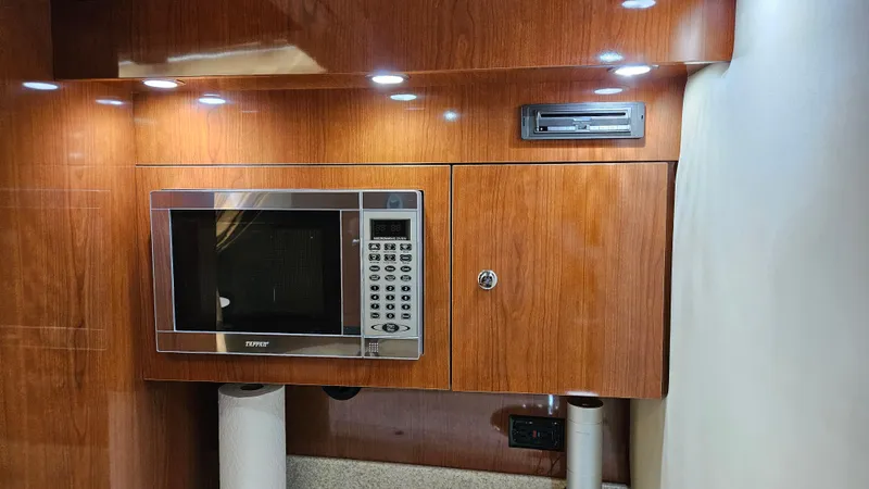  Yacht Photos Pics 2007 Regal 3760 Commodore interior with microwave and wooden cabinetry.