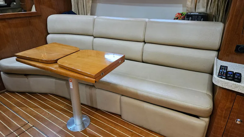  Yacht Photos Pics 2007 Regal 3760 Commodore interior with beige leather seating and wooden table.