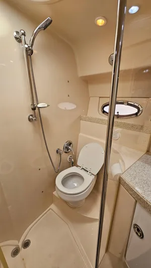  Yacht Photos Pics 2007 Regal 3760 Commodore bathroom with shower, toilet, and porthole window.