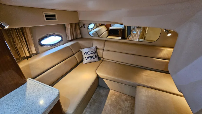  Yacht Photos Pics Luxurious interior of 2007 Regal 3760 Commodore yacht with beige seating and "Good Vibes" pillow.