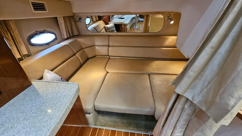  Yacht Photos Pics Interior of 2007 Regal 3760 Commodore yacht with beige leather seating and porthole window.