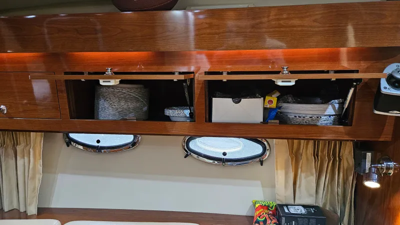  Yacht Photos Pics 2007 Regal 3760 Commodore interior storage with open cabinets and portholes.