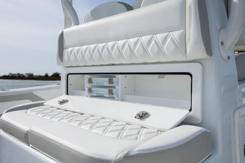  Yacht Photos Pics 2025 Yellowfin 34 Offshore boat with white cushioned seating and storage compartment.