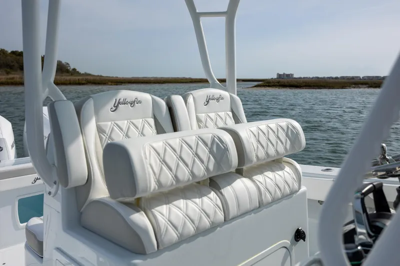  Yacht Photos Pics 2025 Yellowfin 34 Offshore boat with luxurious white seating on open water.