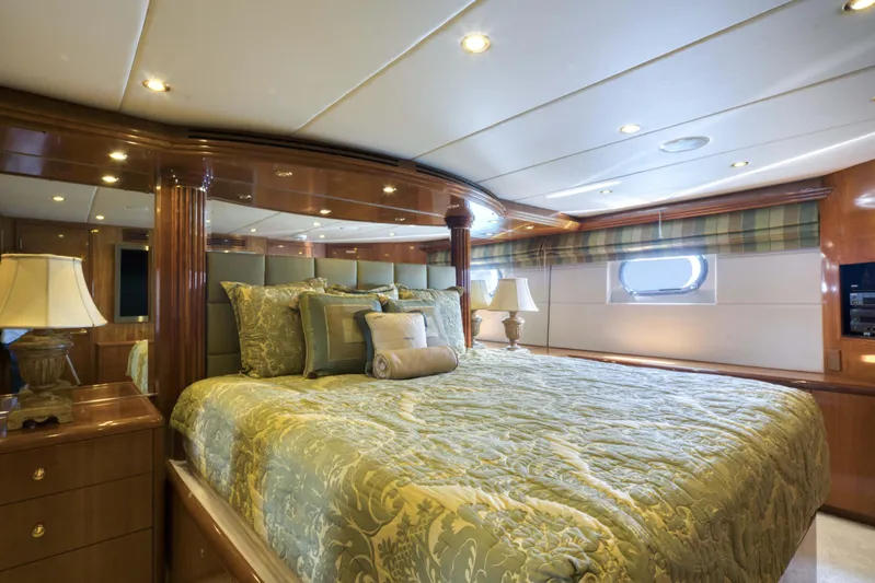 Spherefish Yacht Photos Pics Luxurious bedroom interior of 2003 Hatteras 86 Convertible yacht with elegant bedding and wood finishes.