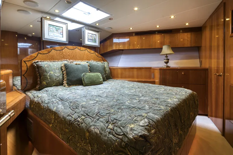Spherefish Yacht Photos Pics Luxurious bedroom interior of 2003 Hatteras 86 Convertible yacht with elegant wood finishes.