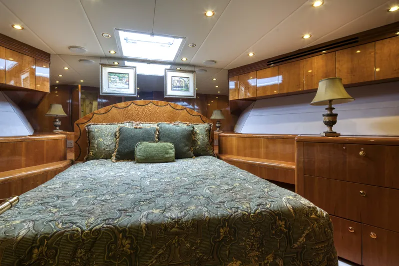 Spherefish Yacht Photos Pics Luxurious bedroom interior of 2003 Hatteras 86 Convertible yacht with elegant wood finishes.