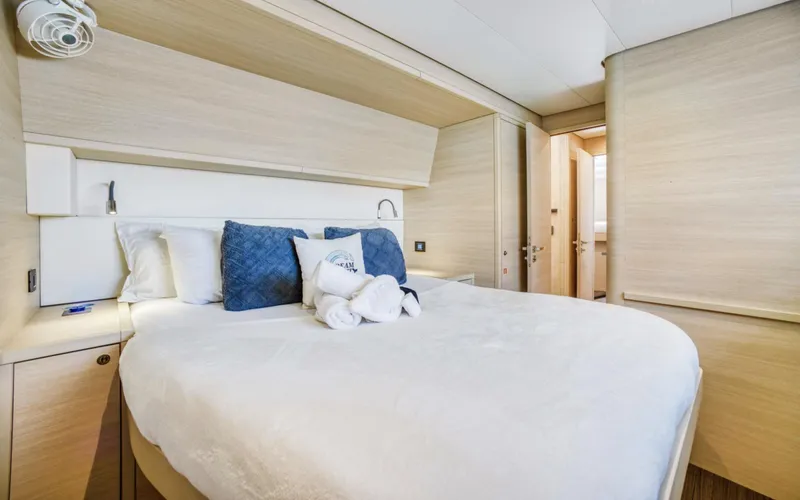 Dream Beauty Yacht Photos Pics Luxurious bedroom interior of 2020 Lagoon 620 yacht with elegant bedding and modern design.