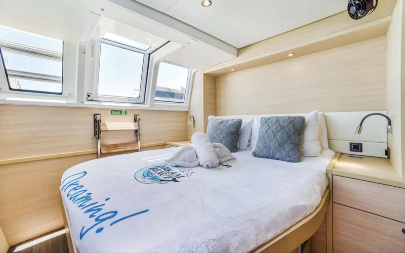 Dream Beauty Yacht Photos Pics Luxurious cabin interior of 2020 Lagoon 620 yacht with cozy bed and natural light.