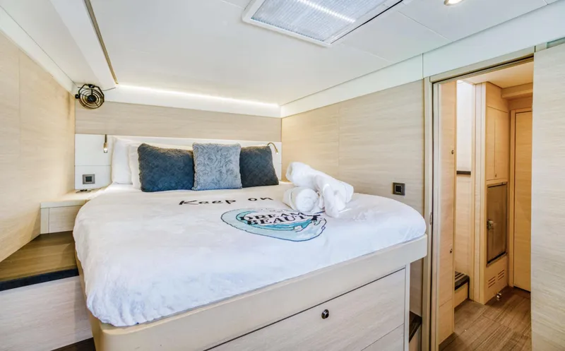 Dream Beauty Yacht Photos Pics Luxurious bedroom interior of 2020 Lagoon 620 yacht with cozy bedding and modern design.