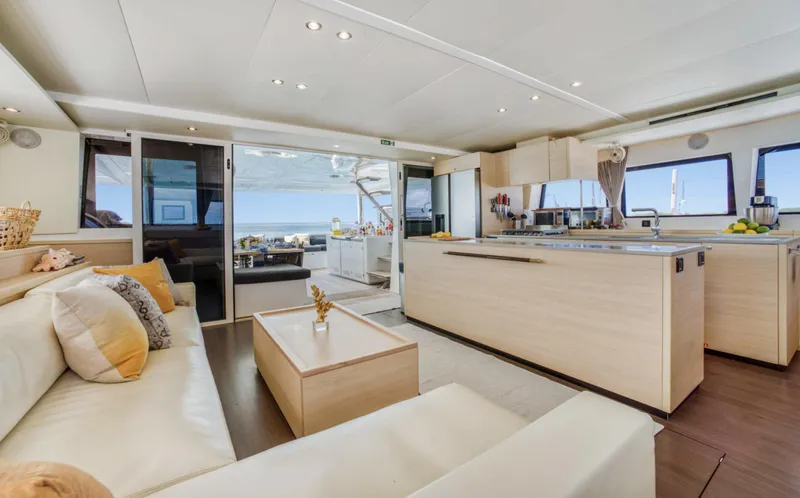 Dream Beauty Yacht Photos Pics Luxurious interior of 2020 Lagoon 620 yacht with modern kitchen and seating area.