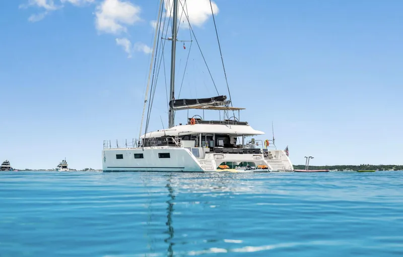 Dream Beauty Yacht Photos Pics 2020 Lagoon 620 catamaran sailing on clear blue water under a sunny sky.