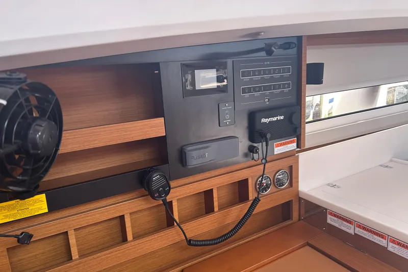 Yours To Name Yacht Photos Pics 2026 Jeanneau 440 Sun Odyssey interior control panel with navigation equipment and wood finish.