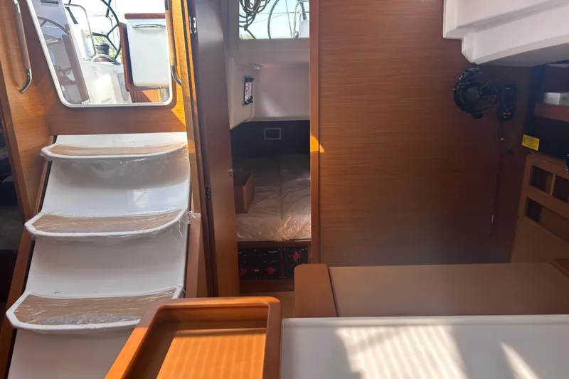 Yours To Name Yacht Photos Pics Interior of 2026 Jeanneau 440 Sun Odyssey yacht, featuring stairs and cabin area.
