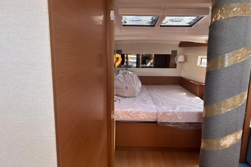 Yours To Name Yacht Photos Pics Interior cabin of 2026 Jeanneau 440 Sun Odyssey yacht, featuring a cozy bed.