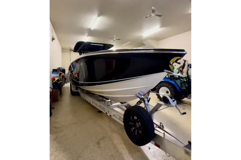  Yacht Photos Pics 2020 Nor-Tech 390 Sport Center Console boat on trailer in a garage.