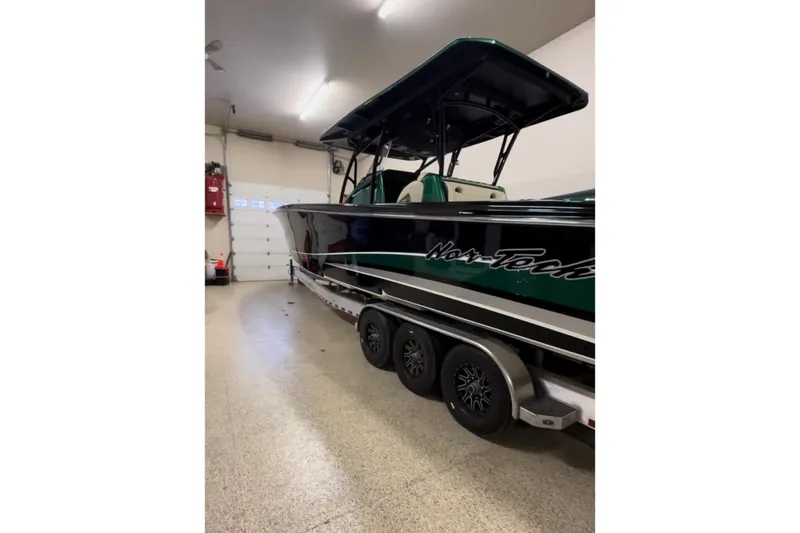  Yacht Photos Pics 2020 Nor-Tech 390 Sport Center Console boat in garage, on trailer, side view.